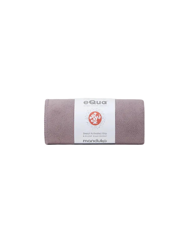 Manduka eQua yoga mat rolled up on a white background