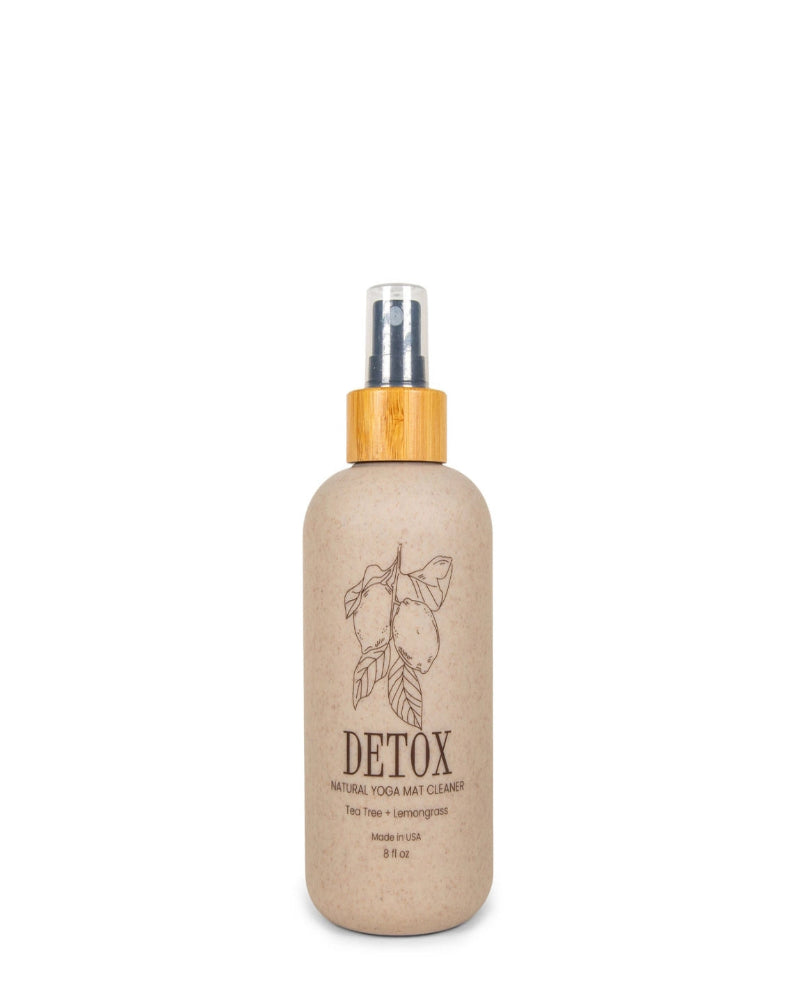 Detox natural yoga mat cleaner bottle with a wooden cap on a white background