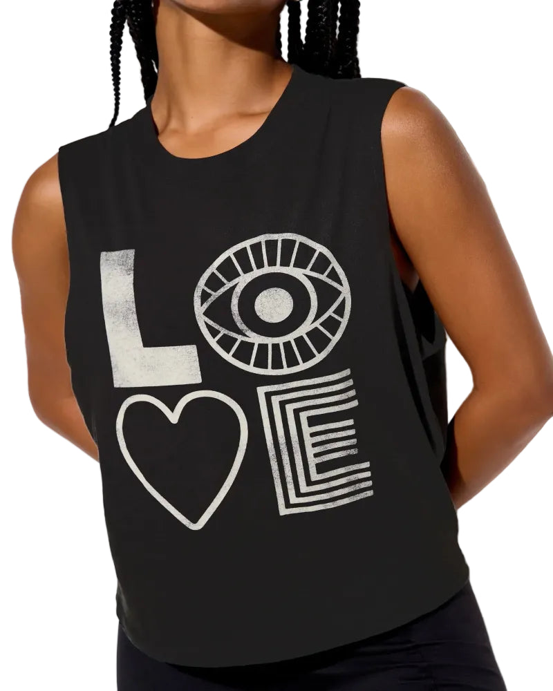Black sleeveless shirt with white graphic design on a person against a neutral background