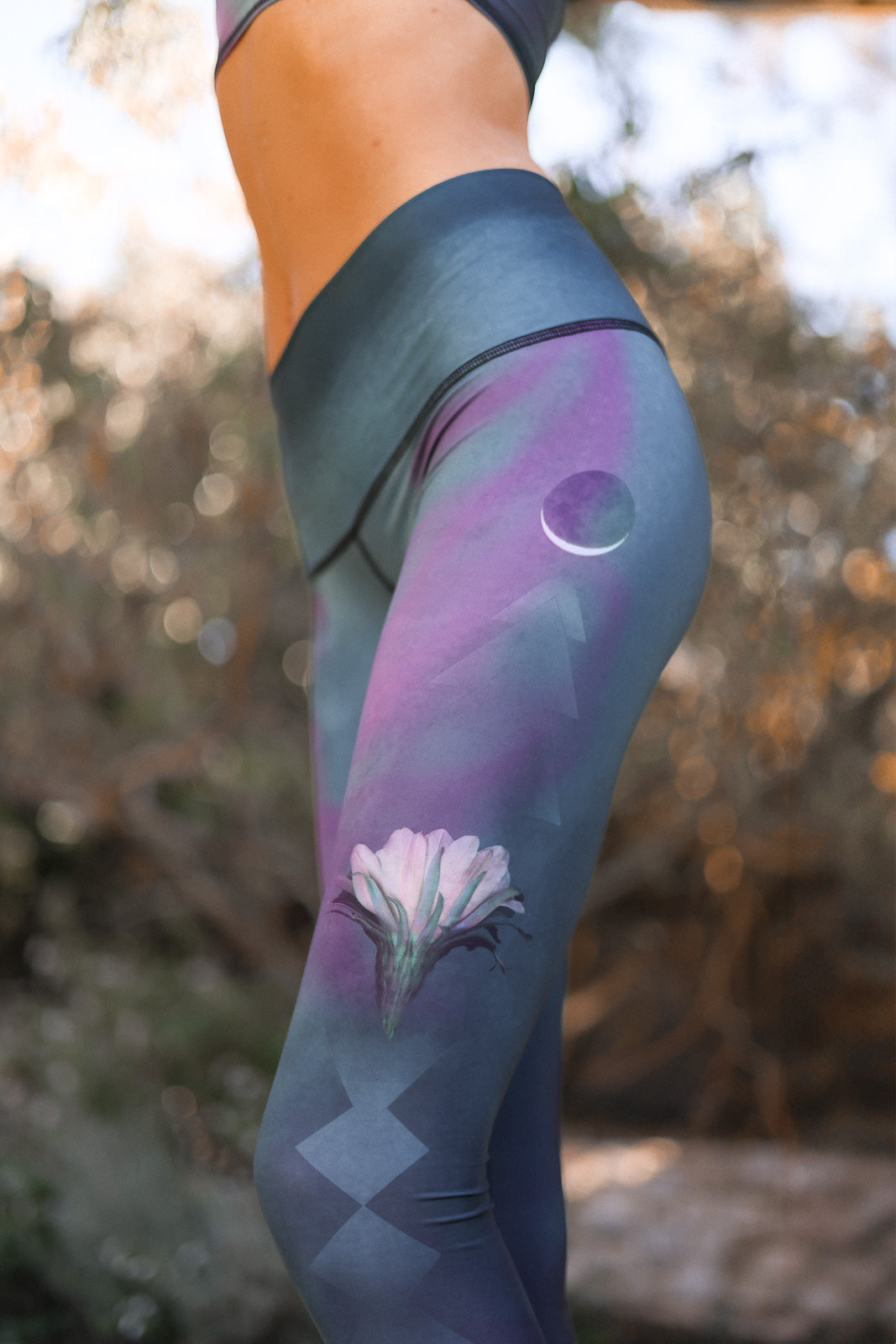 Leggings with a floral design and geometric patterns worn by a person outdoors.