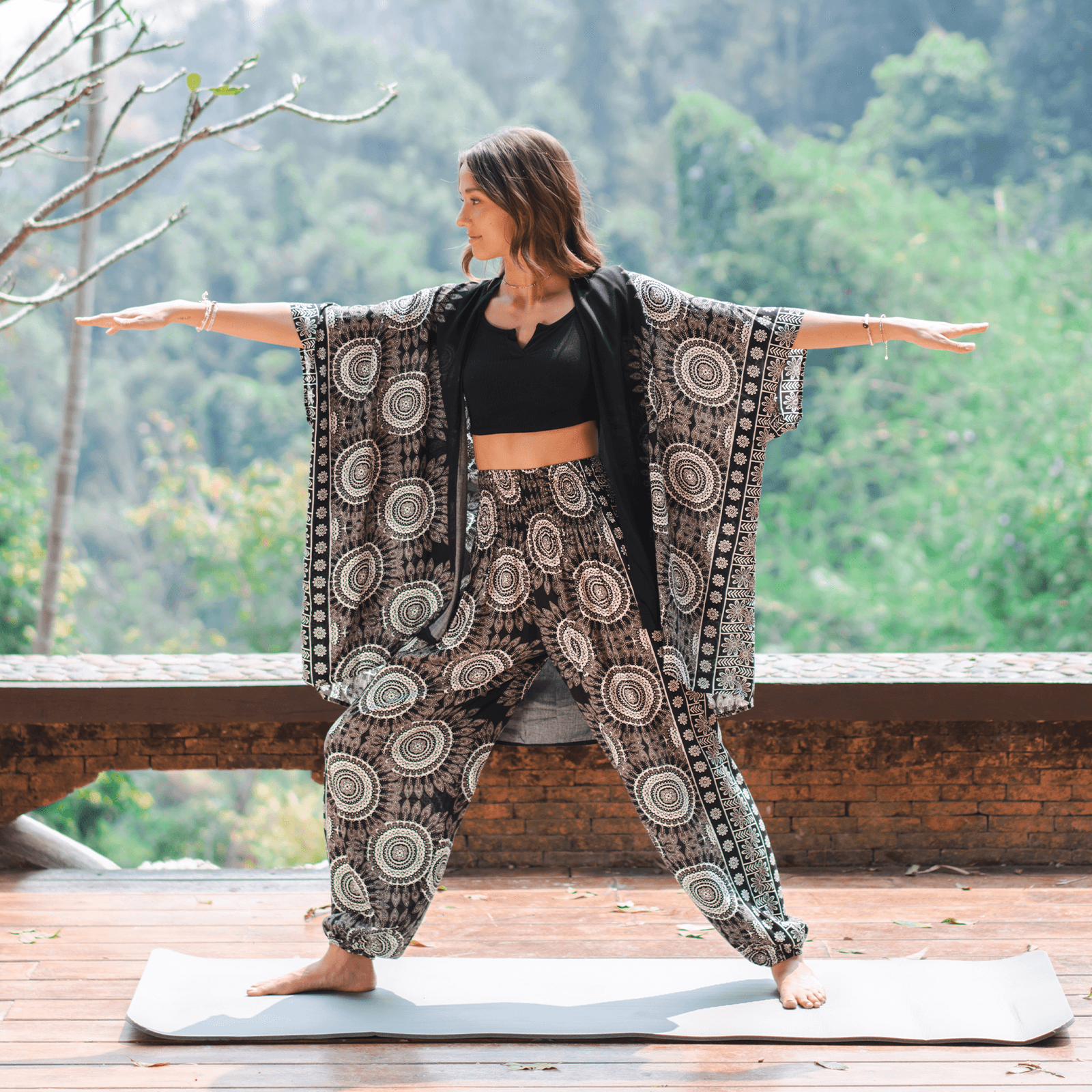 Woman practicing yoga outdoors with a scenic background