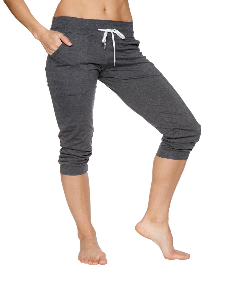 Gray capri pants worn by a person on a white background