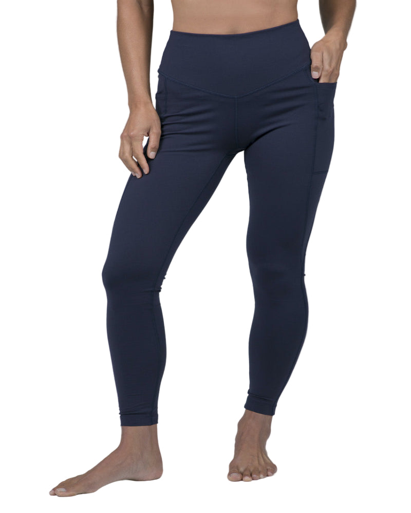 Navy leggings worn by a person on a gray background