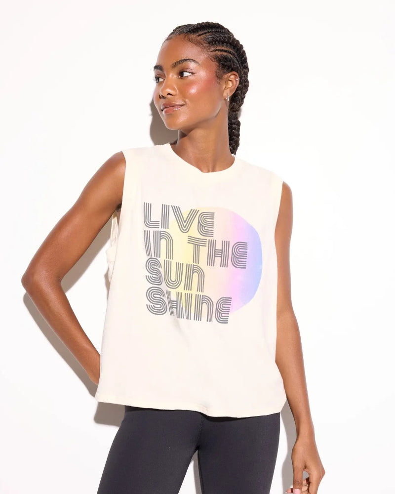 Woman wearing a sleeveless shirt with 'Live in the Sunshine' text on a white background
