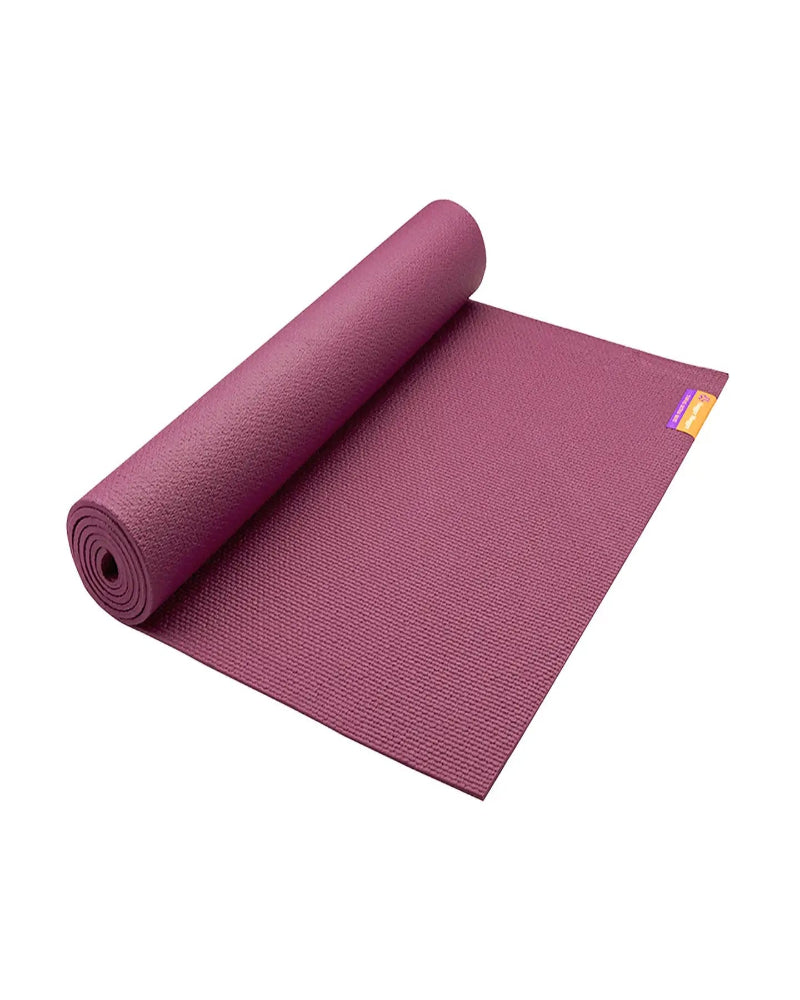 Purple yoga mat rolled out on a white background
