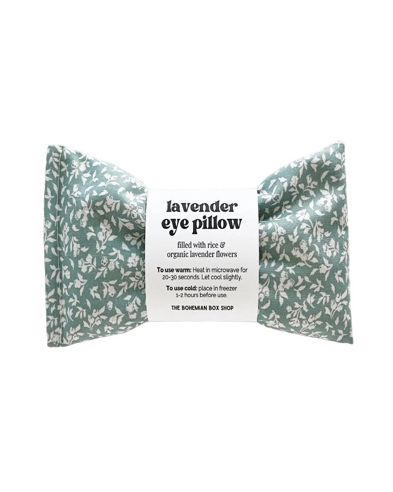 Lavender eye pillow with floral pattern and label on a white background