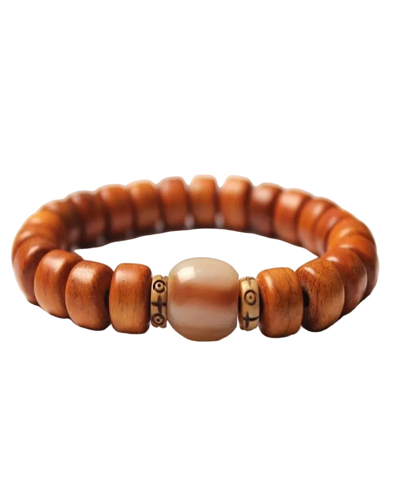 Wooden beaded bracelet with a central cream bead on a white background