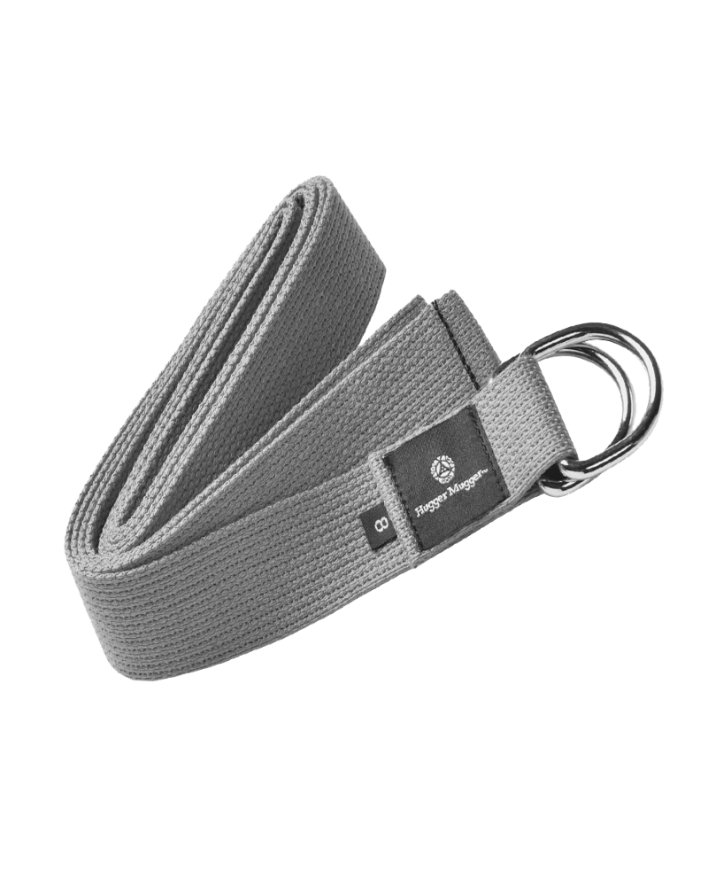A gray woven yoga strap with a black brand label and a silver metal D-ring, shown on a plain white background.