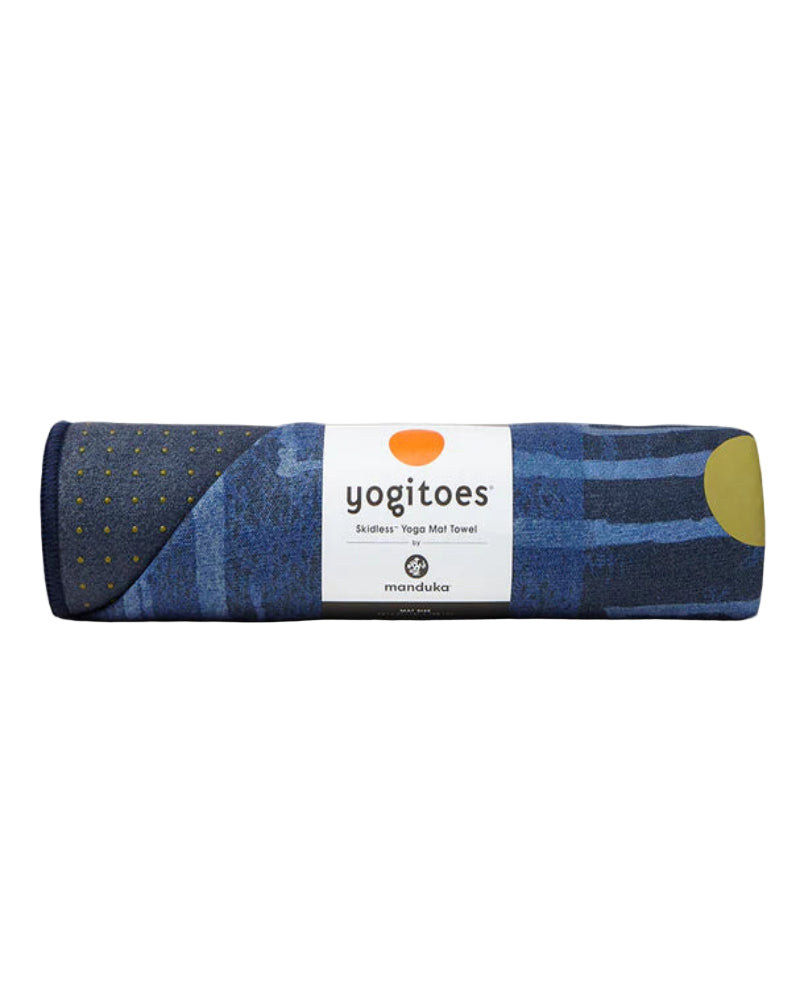 Rolled-up yoga mat with 'yogitoes' label on a white background