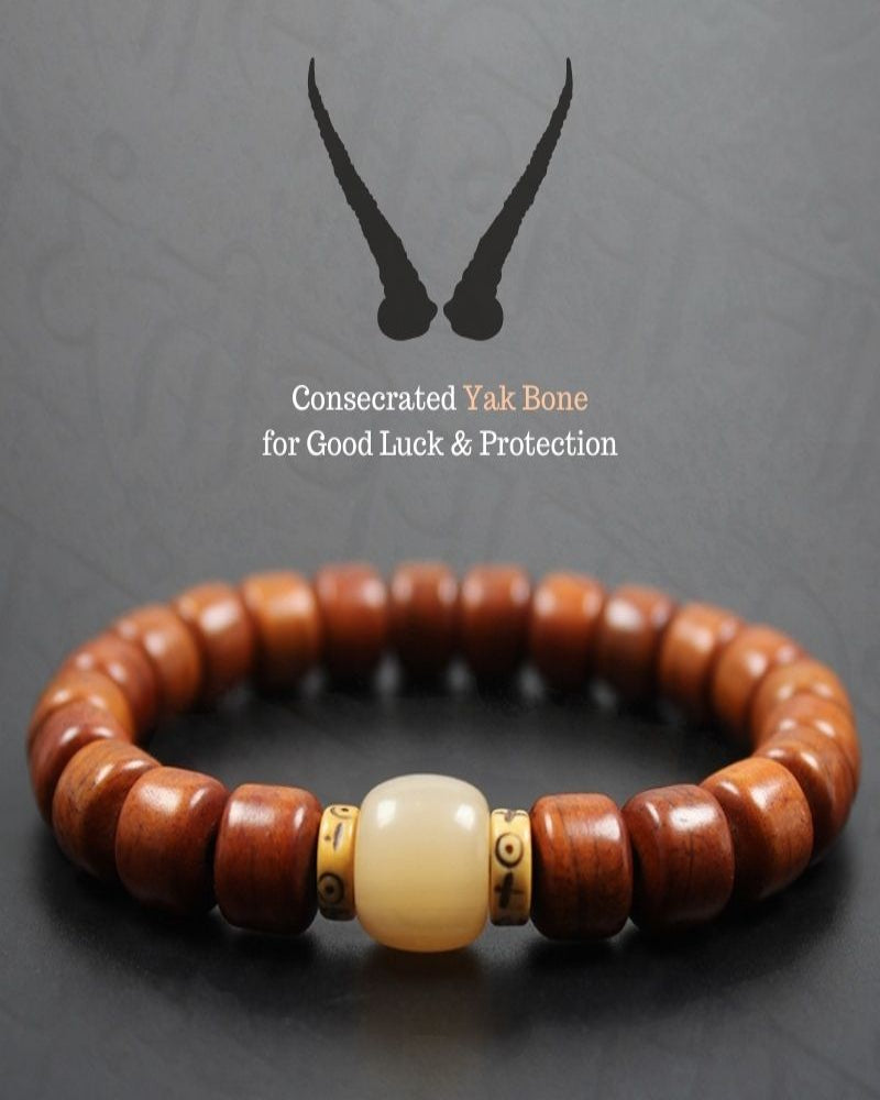Wooden beaded bracelet with a central yellow bead on a gray background