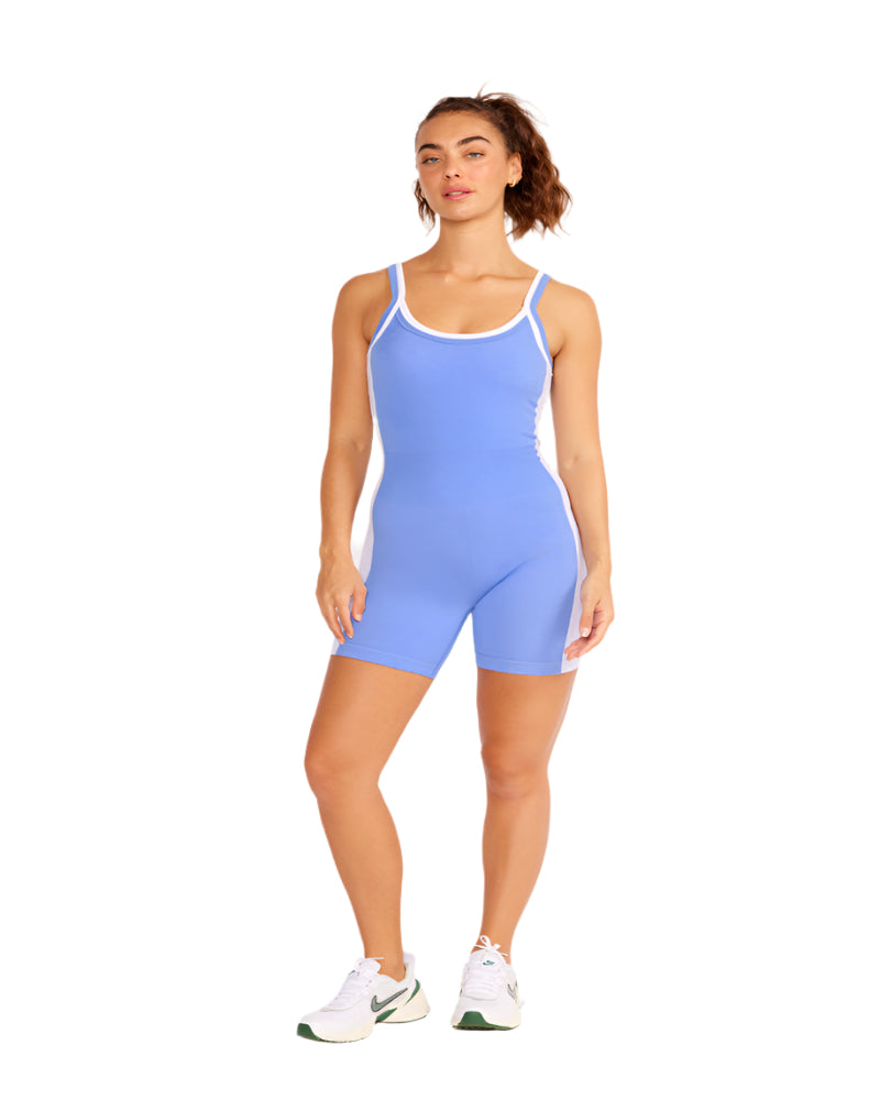 Woman wearing a light blue bodysuit on a white background
