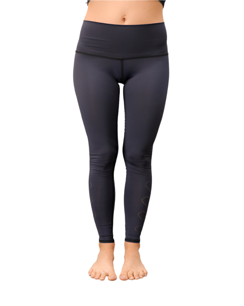 Navy blue leggings with heart patterns on a plain background