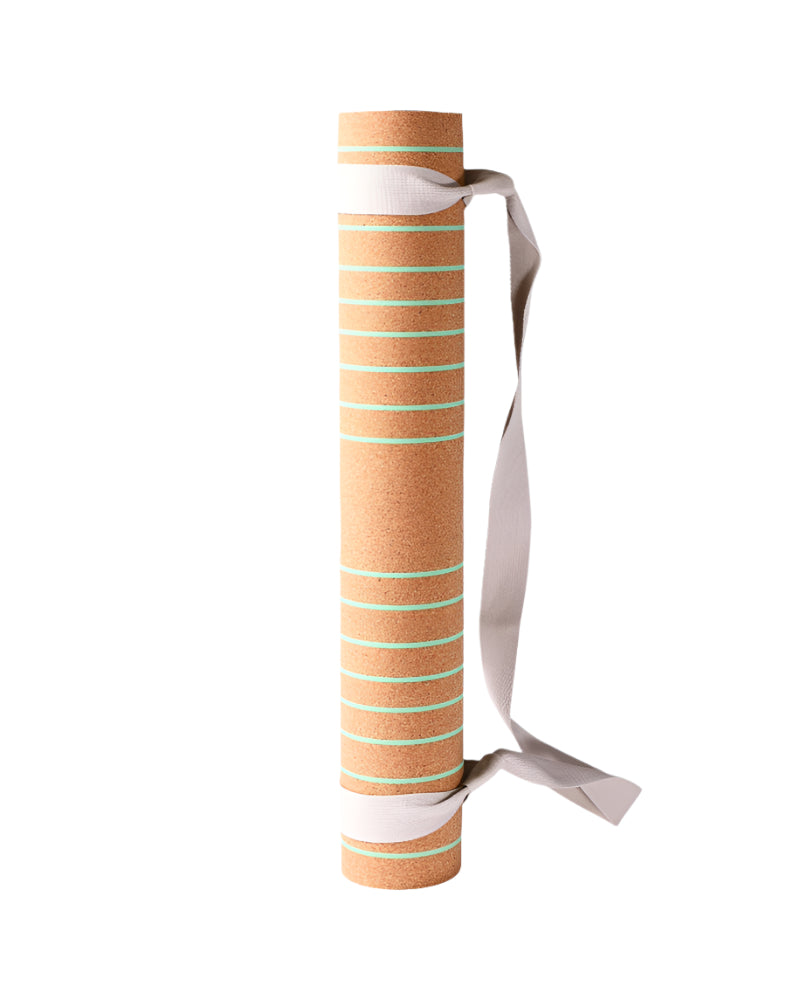 Striped yoga mat with a strap on a white background