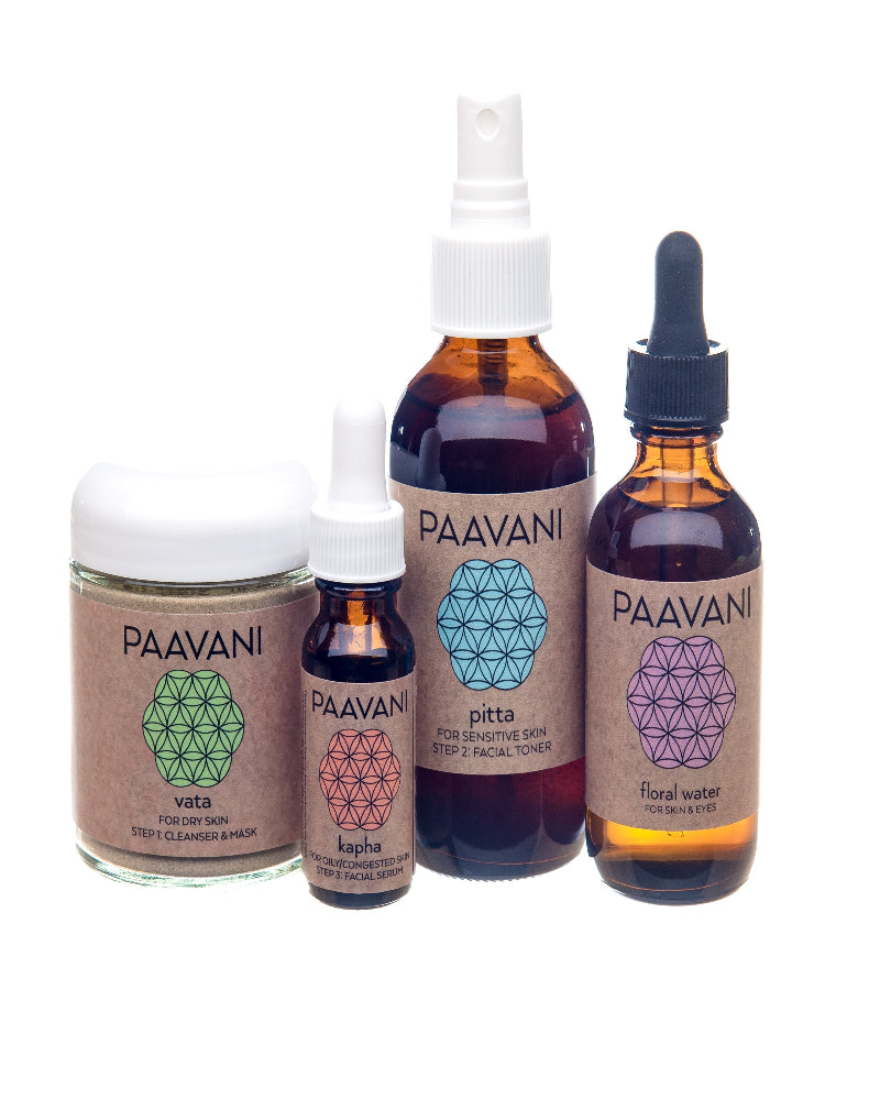Set of Paavani skincare products including a jar, bottles with different applicators on a white background.