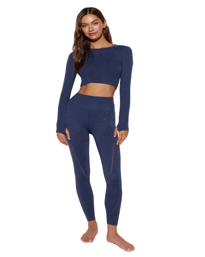 Woman wearing a blue athletic outfit on a white background