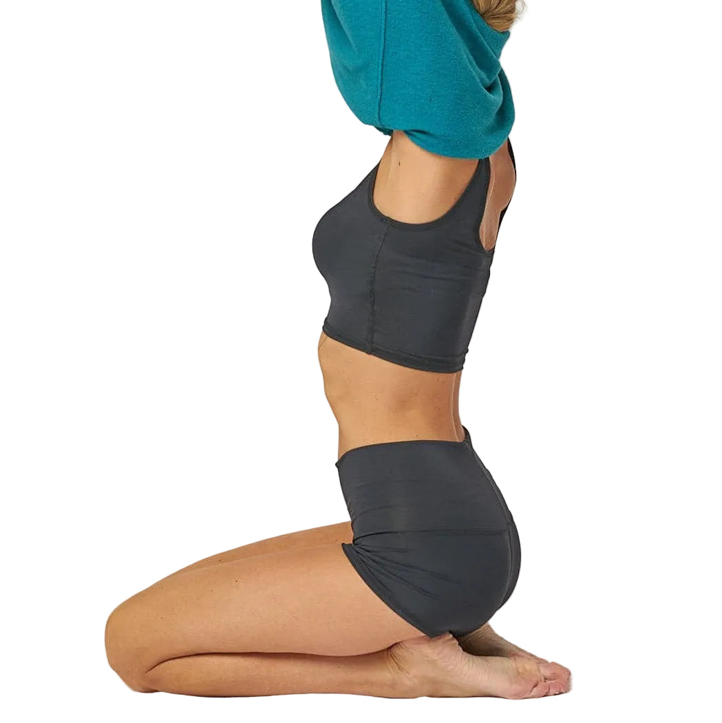 Person wearing dark gray athletic shorts on a white background