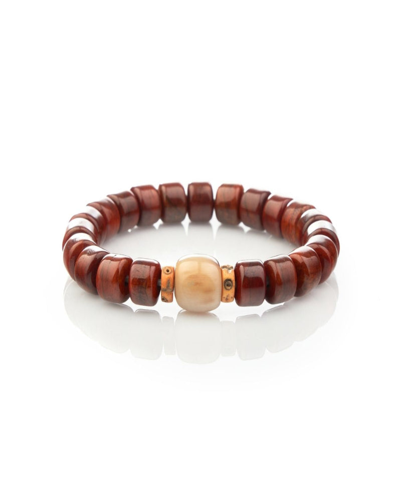 Beaded bracelet with brown and beige beads on a white background