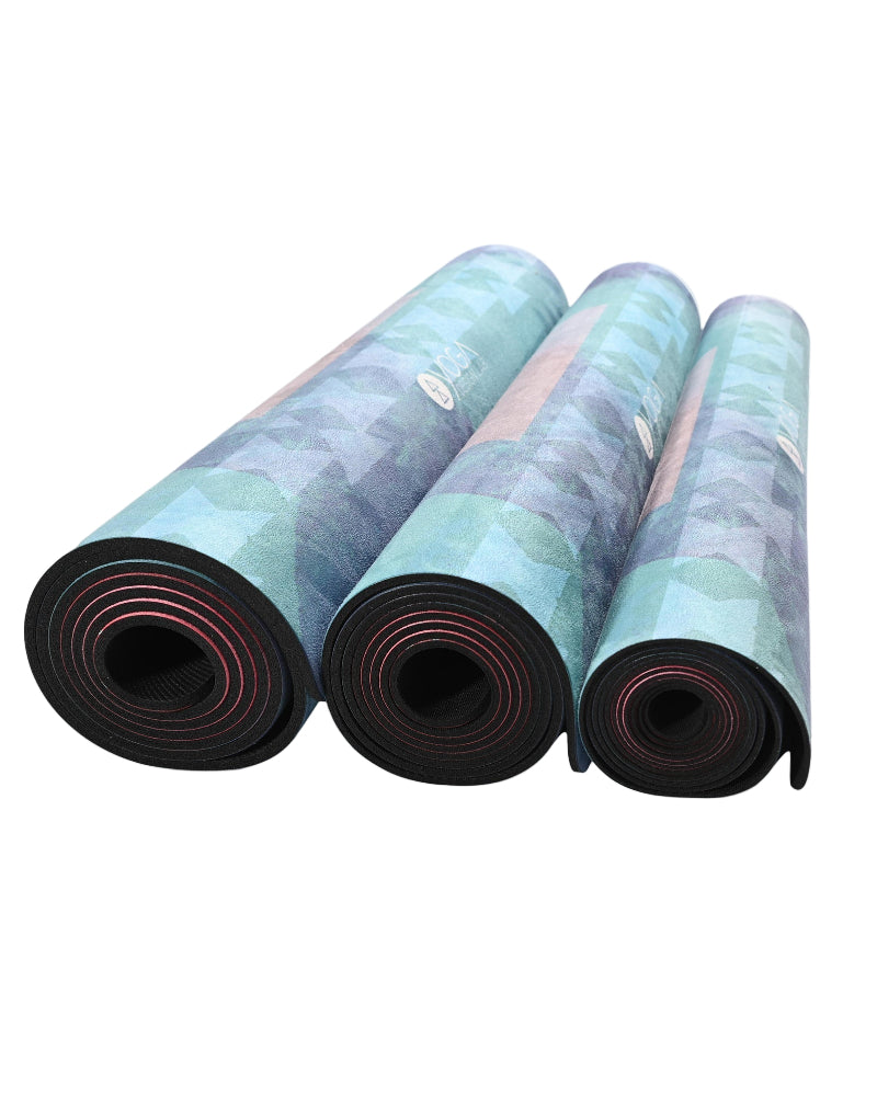 Three rolled-up yoga mats with a gradient design on a white background