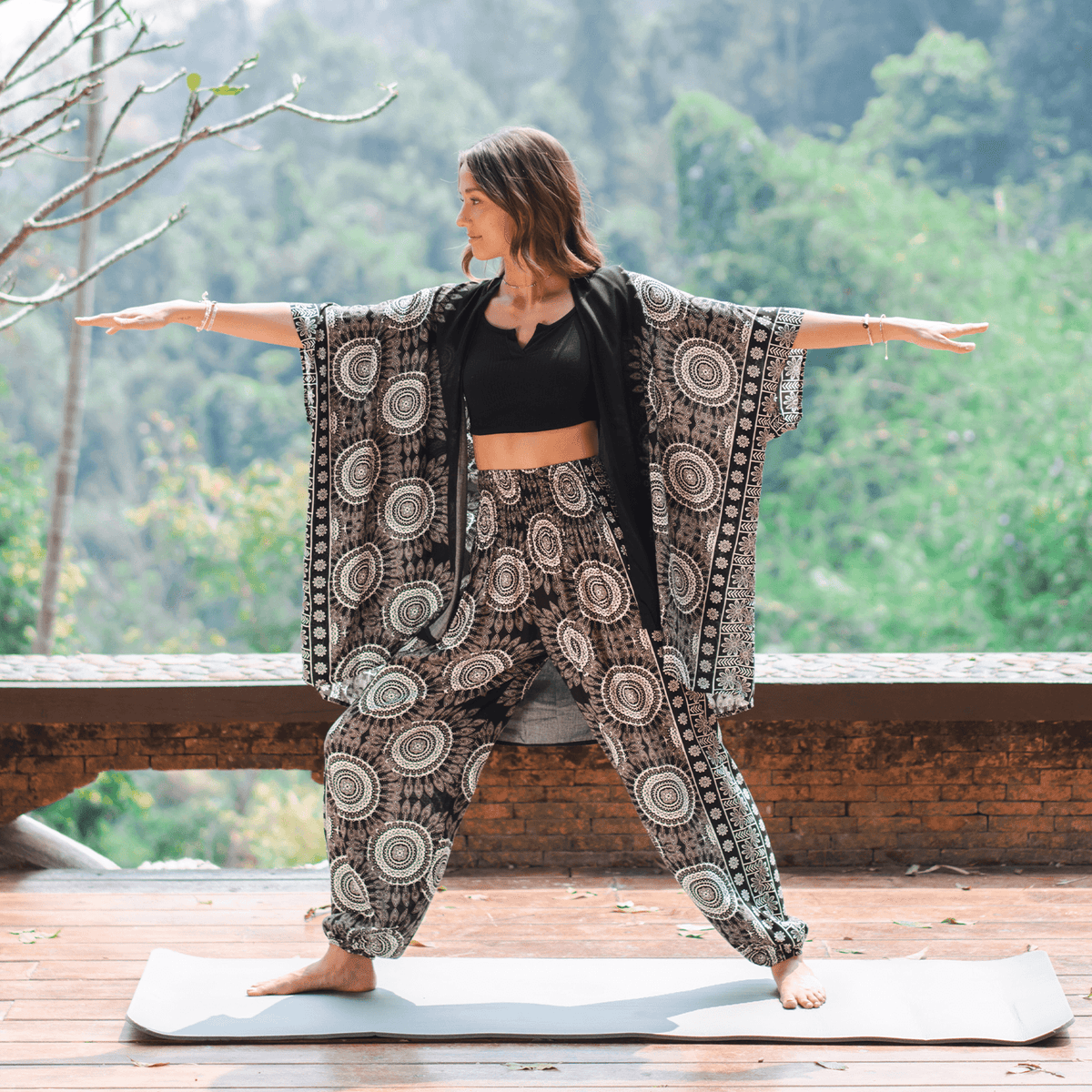 Woman practicing yoga outdoors with a scenic background