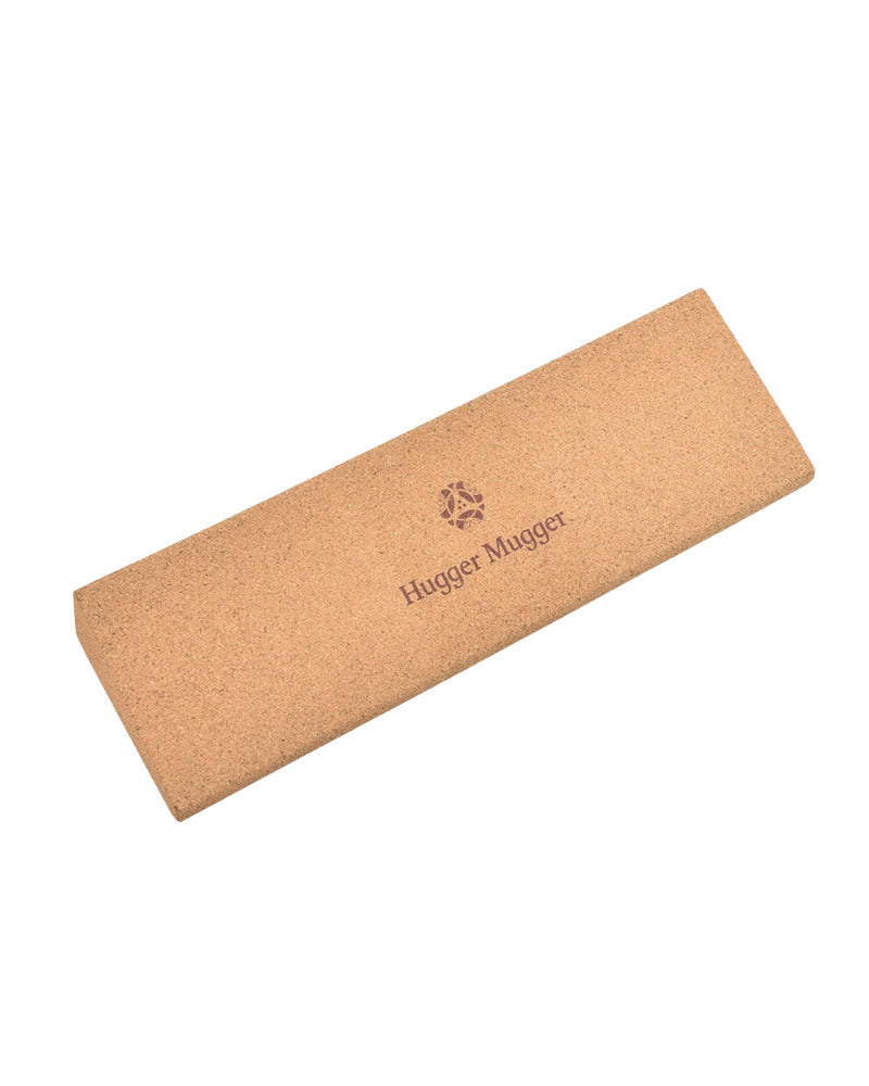 Cork mat with 'Hugger Mugger' branding on a white background