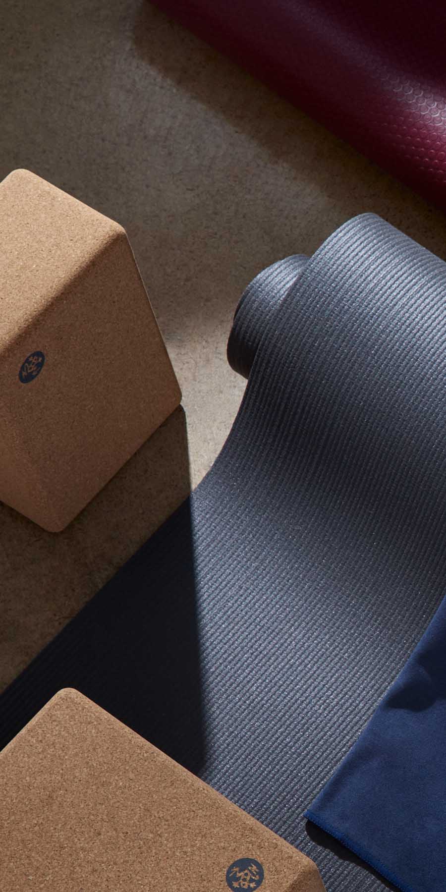 Yoga mat and blocks on a wooden surface