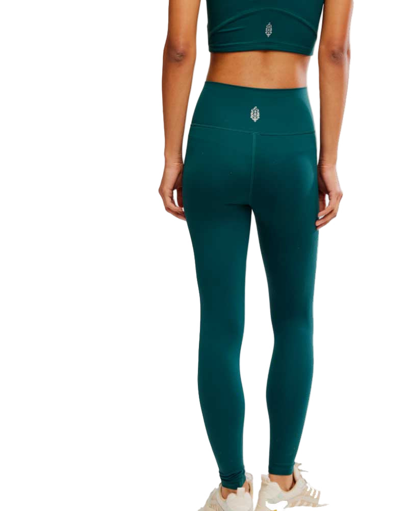 Teal leggings worn by a person on a white background