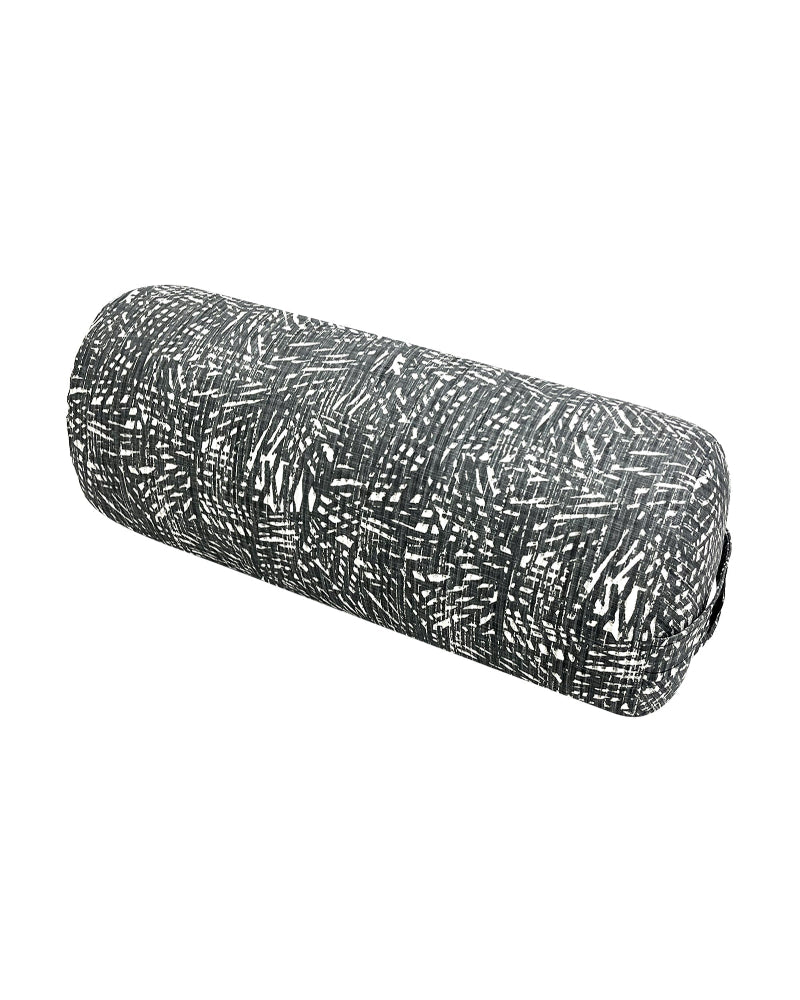 Black and white patterned cylindrical yoga bolster on a white background