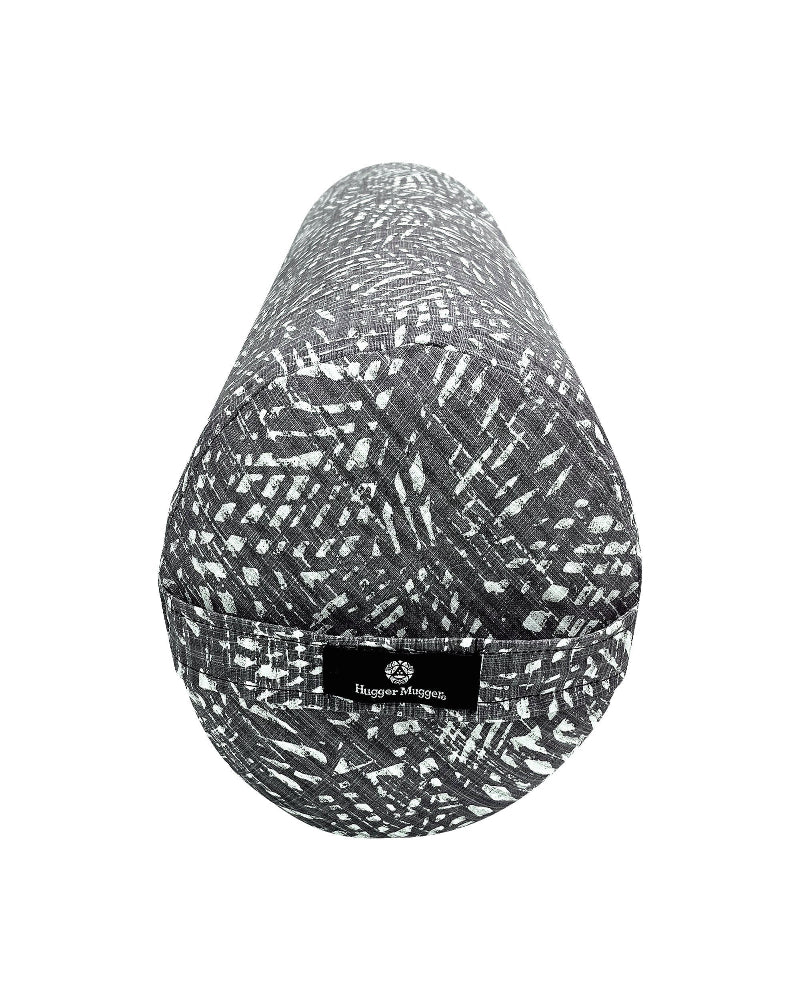 Gray and white patterned cylindrical pillow with a brand label on a white background
