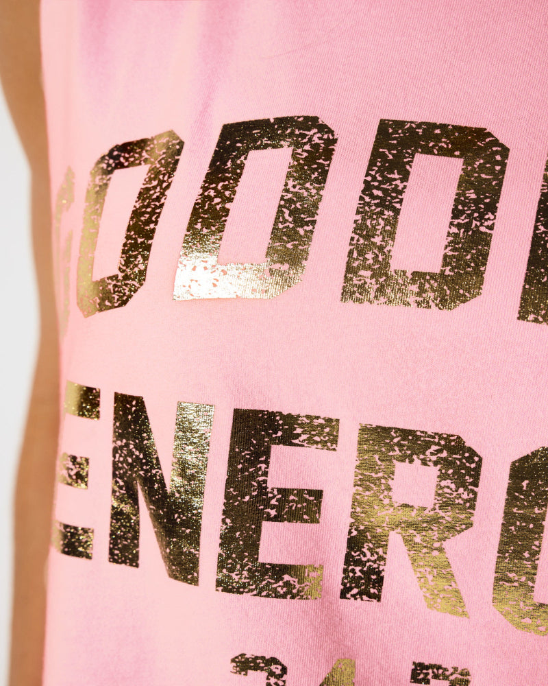 Close up of Spiritual Gangster Goddess gold foil graphic on soft worn-in tank top