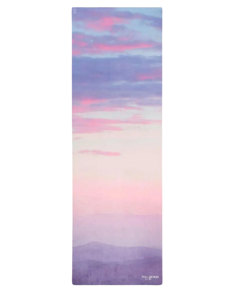 Yoga mat with a colorful gradient design on a white background